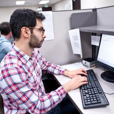 Student sitting at desk typing